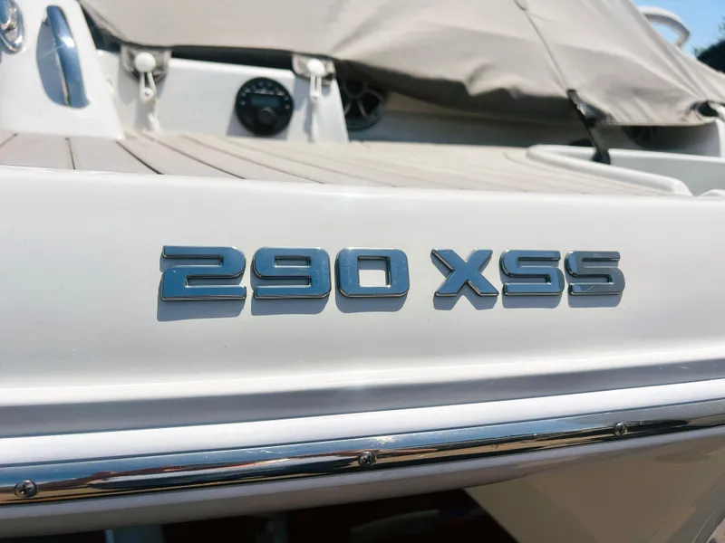 Slide: The Image of 2025 Crownline 290 XSS boat emblem on white surface. - 5