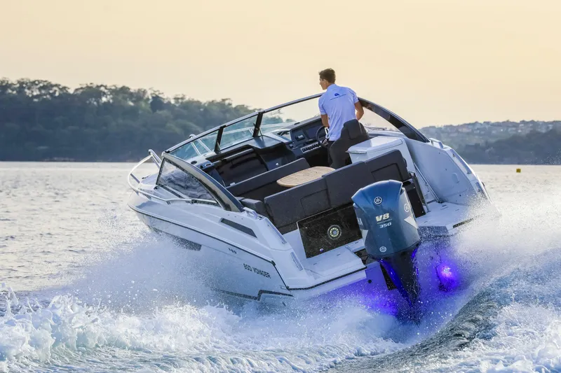 Slide: The Image of 2024 Skamander 850 Voyager boat cruising on water with outboard motor. - 13