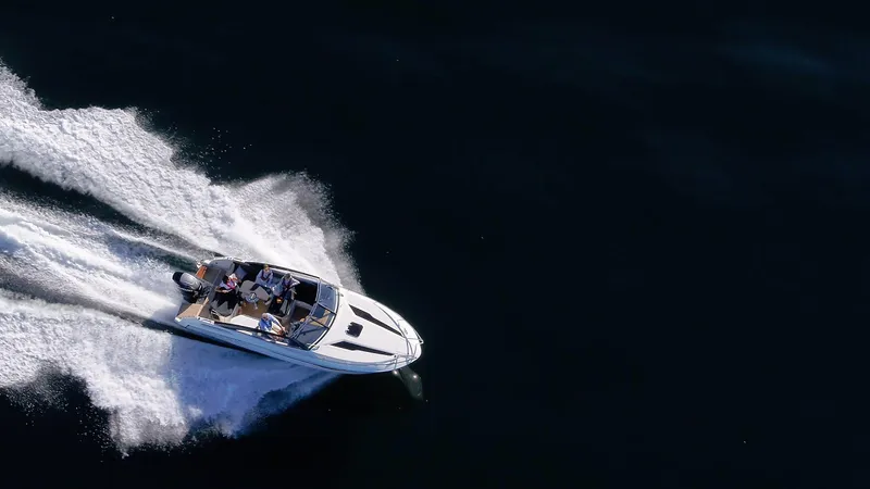 Slide: The Image of 2024 Skamander 850 Voyager speedboat cruising on open water. - 18