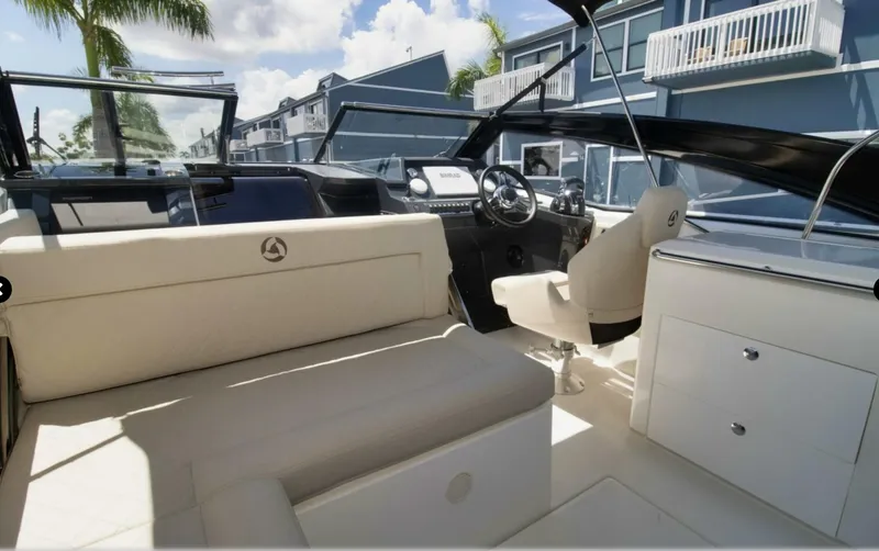 Slide: The Image of 2024 Skamander 850 Voyager boat interior with modern seating and steering console. - 23
