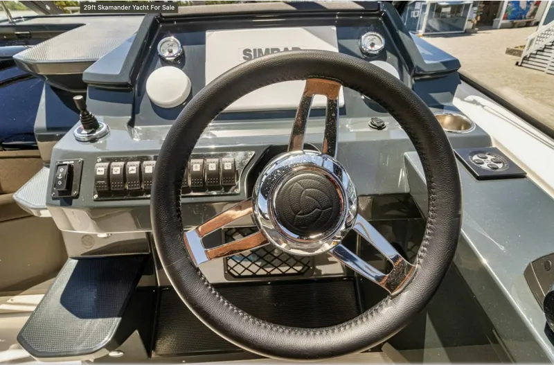 Slide: The Image of Steering wheel of 2024 Skamander 850 Voyager yacht with control panel. - 25