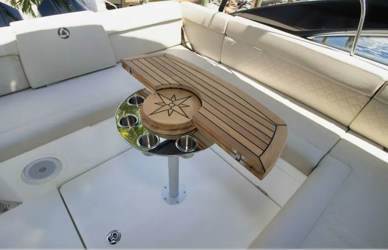 Slide: The Image of Luxurious seating area on 2024 Skamander 850 Voyager boat with wooden table and cup holders. - 27