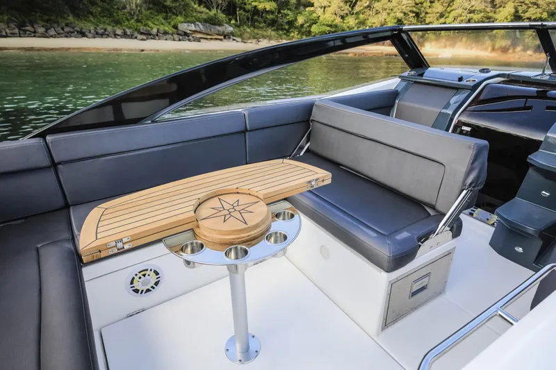 Slide: The Image of Luxurious interior of 2024 Skamander 850 Voyager boat with sleek seating and wooden table. - 8
