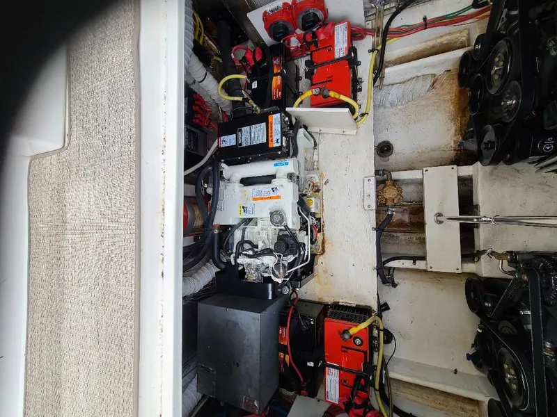 Slide: The Image of Engine compartment of a 2004 Cruisers 3372 boat with visible batteries and wiring. - 10