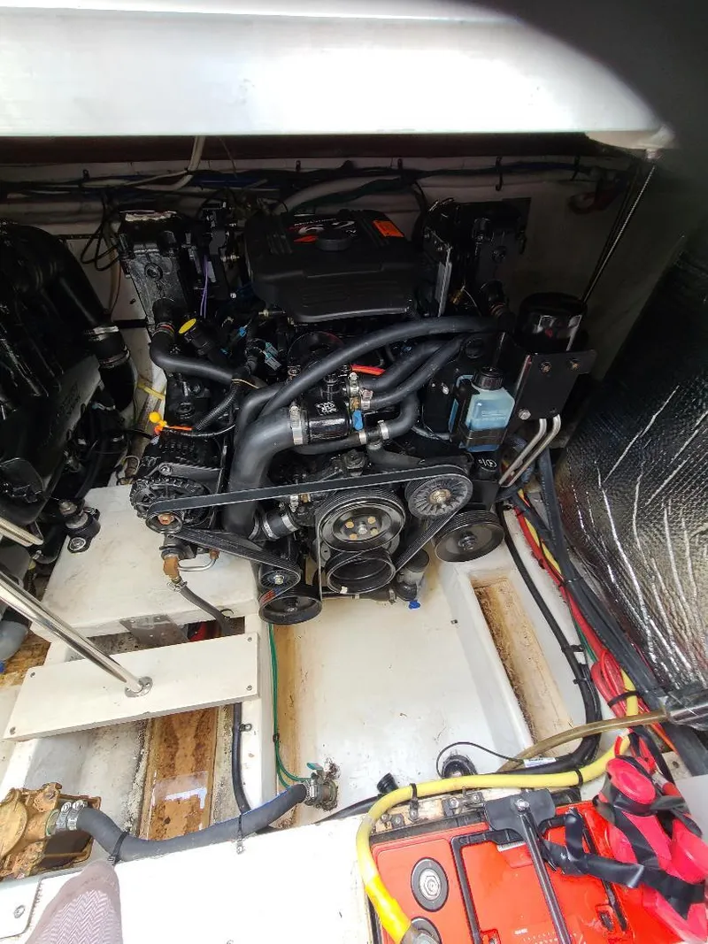 Slide: The Image of Engine compartment of a 2004 Cruisers 3372 boat, showcasing mechanical components. - 11