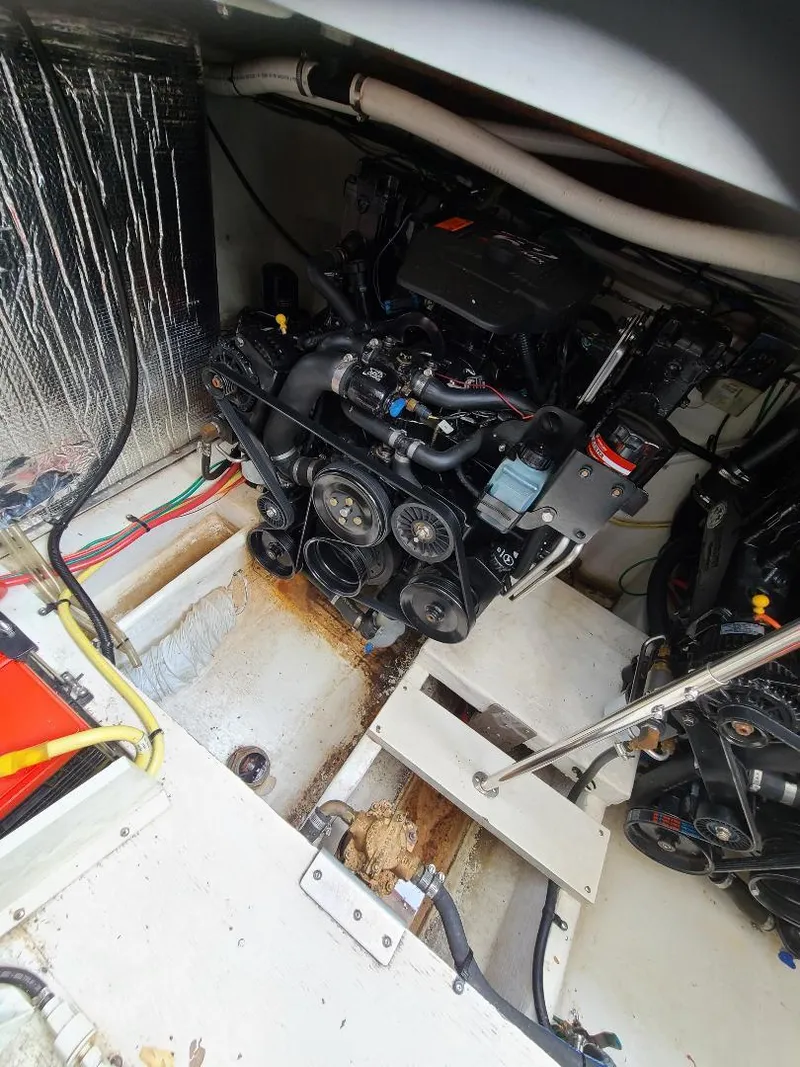 Slide: The Image of Engine compartment of a 2004 Cruisers 3372 boat, showing detailed mechanical components. - 12