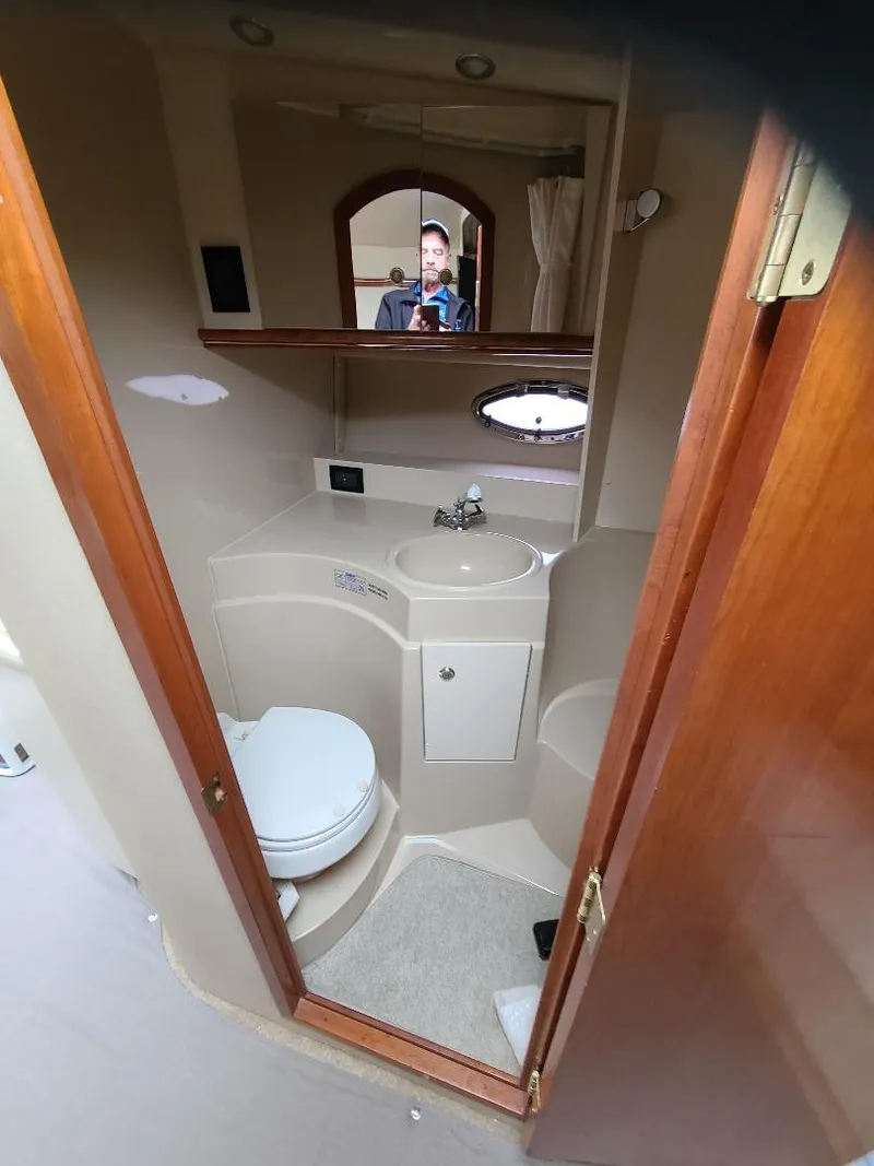 Slide: The Image of 2004 Cruisers 3372 yacht bathroom with sink, toilet, and mirror. - 15