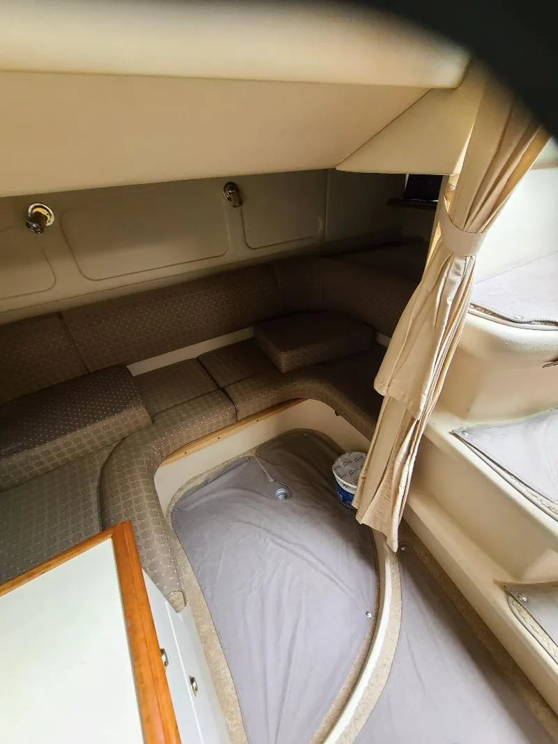 Slide: The Image of 2004 Cruisers 3372 cabin interior with beige upholstery and curtains. - 16