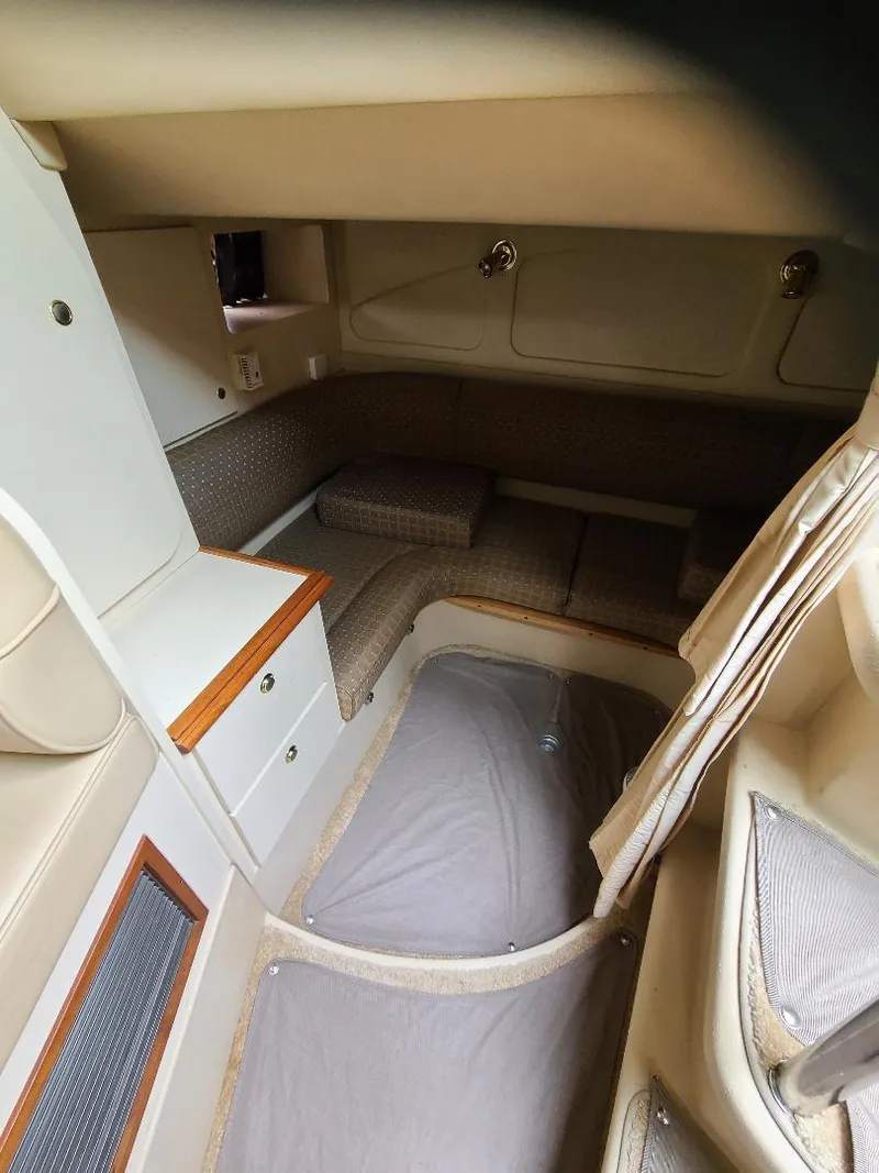 Slide: The Image of Interior cabin of a 2004 Cruisers 3372 boat, featuring seating and storage. - 17