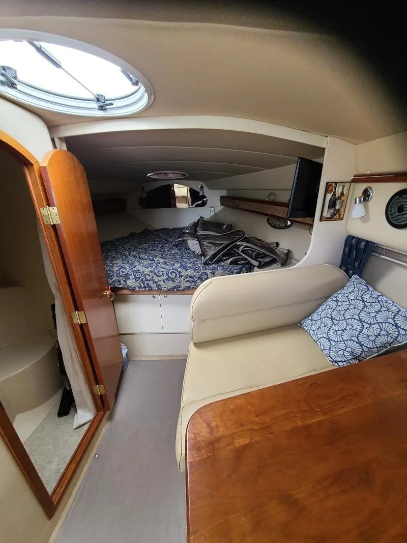 Slide: The Image of 2004 Cruisers 3372 cabin interior with bed, seating, and wooden accents. - 19