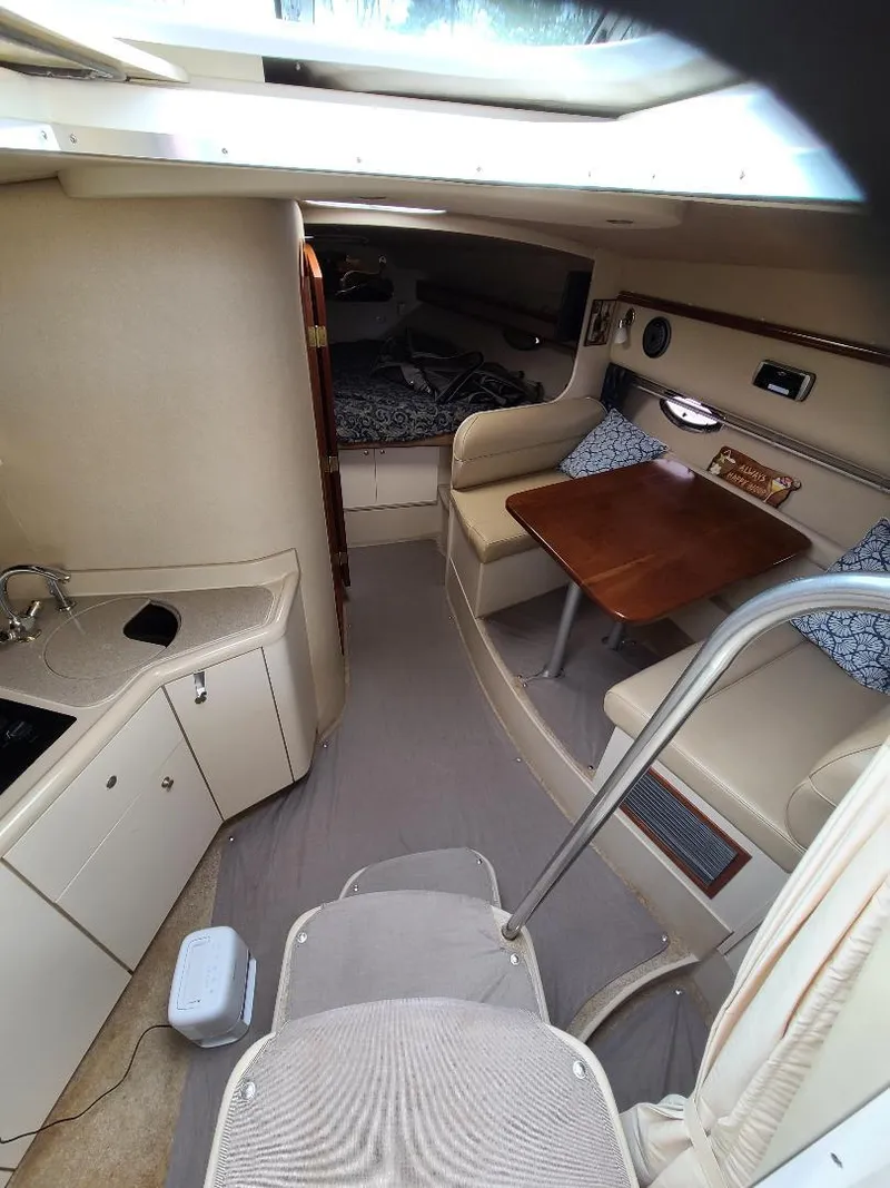 Slide: The Image of 2004 Cruisers 3372 yacht interior with kitchenette, seating area, and sleeping quarters. - 21