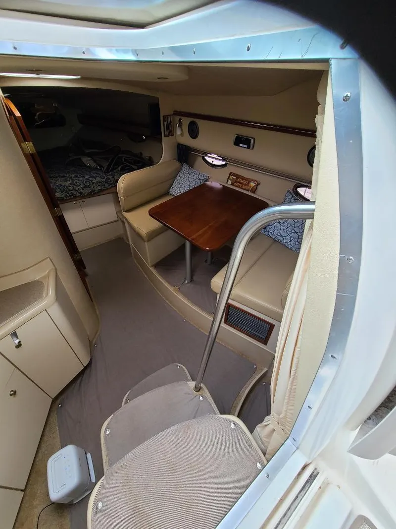 Slide: The Image of 2004 Cruisers 3372 cabin interior with seating, table, and sleeping area. - 22