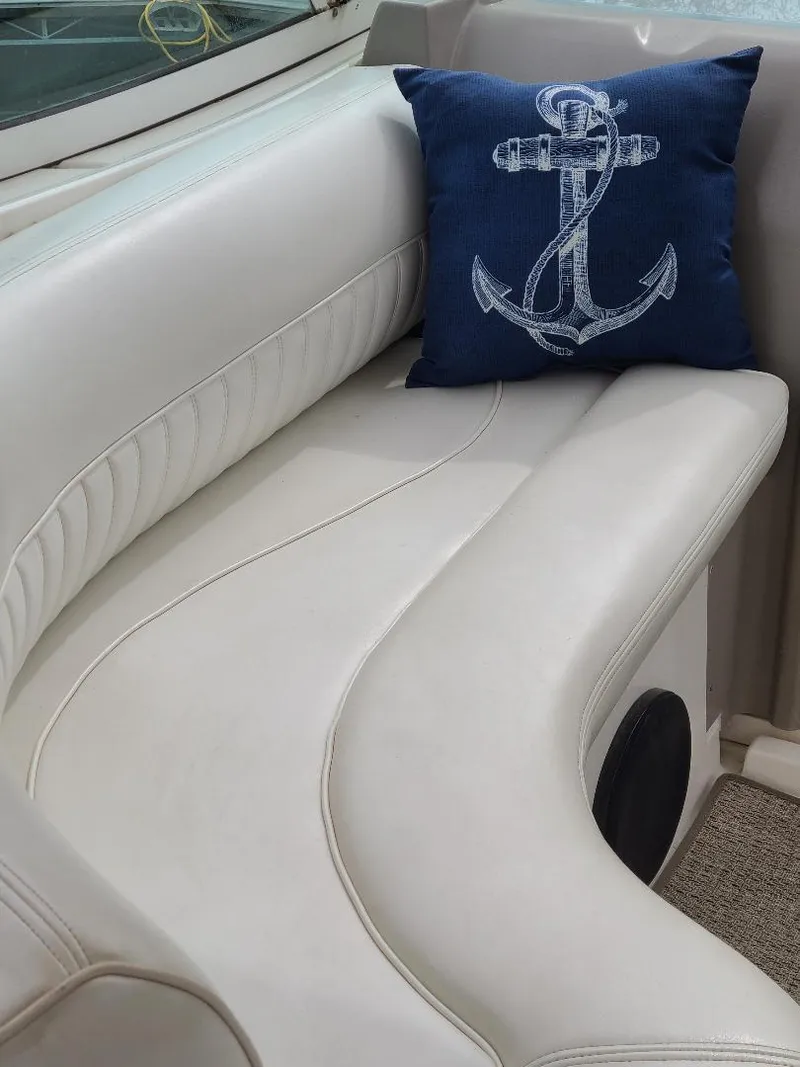Slide: The Image of 2004 Cruisers 3372 boat interior with white seating and anchor-themed pillow. - 28