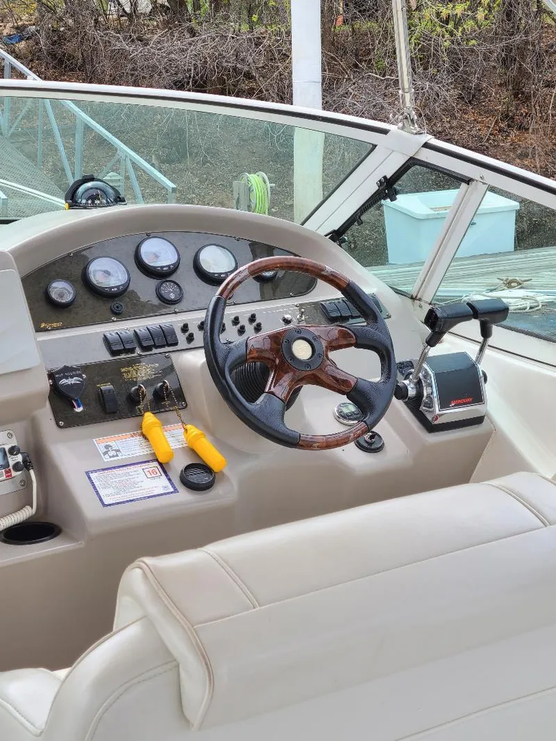 Slide: The Image of 2004 Cruisers 3372 boat helm with steering wheel and control panel. - 29