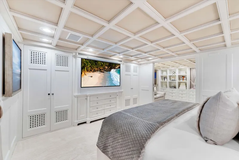 Slide: The Image of Luxurious 1998 Admiral Pilothouse bedroom with elegant decor, large TV, and serene ocean artwork. - 19