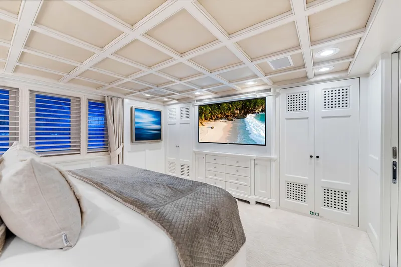 Slide: The Image of Luxurious bedroom interior on 1998 Admiral Pilothouse yacht, featuring elegant decor and ambient lighting. - 21