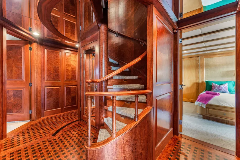 Slide: The Image of Luxurious wooden spiral staircase on 1998 Admiral Pilothouse yacht with elegant floral decor. - 30