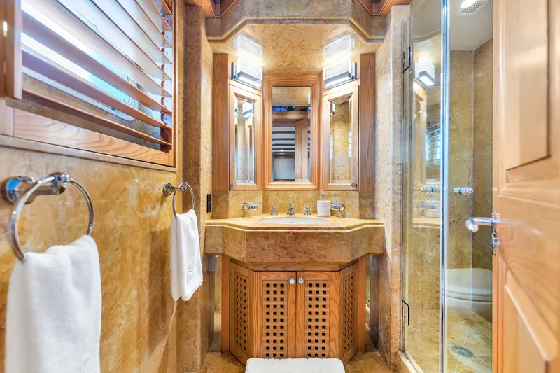 Slide: The Image of Luxurious 1998 Admiral Pilothouse yacht bedroom with twin beds, vibrant decor, and elegant wood finishes. - 32