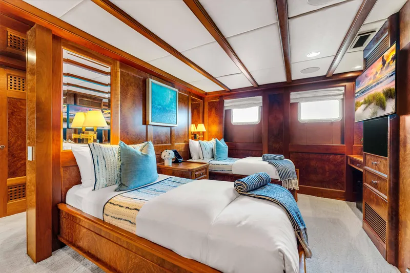 Slide: The Image of Luxurious 1998 Admiral Pilothouse yacht bedroom with elegant wood paneling and plush bedding. - 39
