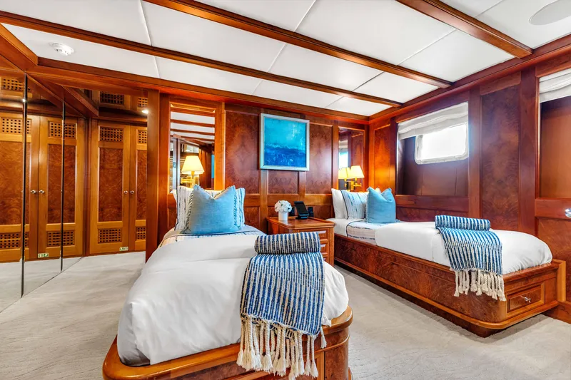 Slide: The Image of Luxurious 1998 Admiral Pilothouse yacht cabin with twin beds, elegant wood paneling, and nautical decor. - 40