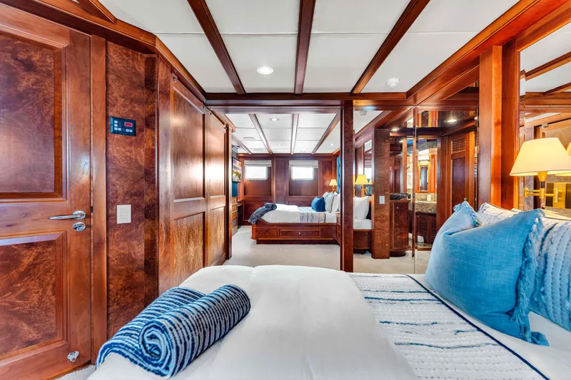 Slide: The Image of Luxurious 1998 Admiral Pilothouse yacht bedroom with twin beds, elegant wood paneling, and nautical decor. - 41