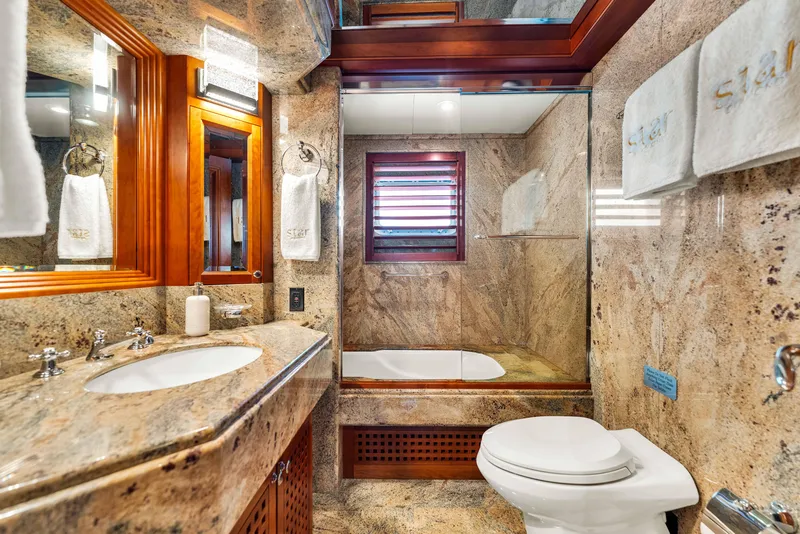 Slide: The Image of Luxurious 1998 Admiral Pilothouse yacht interior with elegant wood paneling and plush bedding. - 42