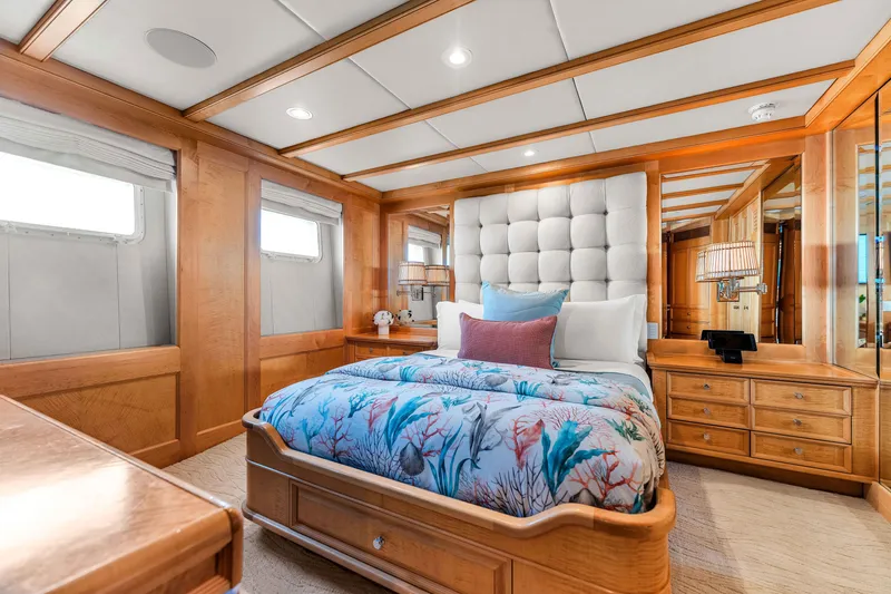 Slide: The Image of Luxurious 1998 Admiral Pilothouse yacht bedroom with elegant wood finishes and plush bedding. - 44