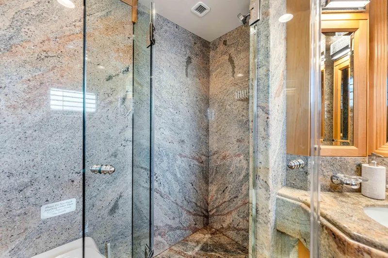 Slide: The Image of Luxurious bathroom in 1998 Admiral Pilothouse yacht with marble and wood accents. - 46