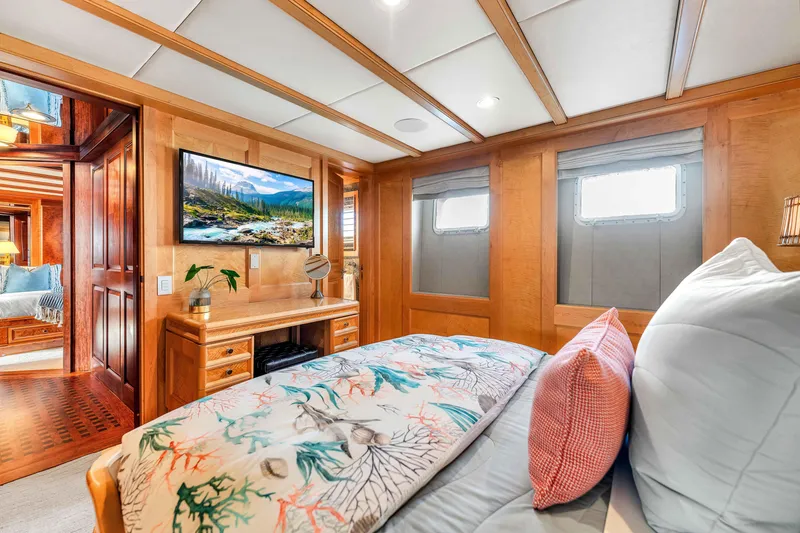 Slide: The Image of Luxurious 1998 Admiral Pilothouse bedroom with elegant decor, TV, and cozy bedding. - 48