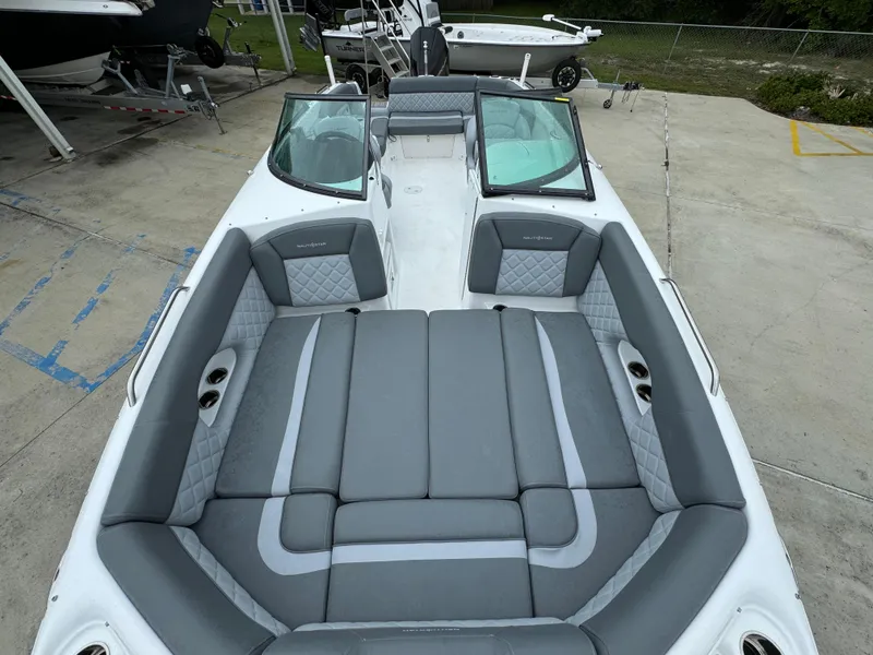 Slide: The Image of 2025 NauticStar 243 DC Deck boat with spacious seating and modern design. - 13
