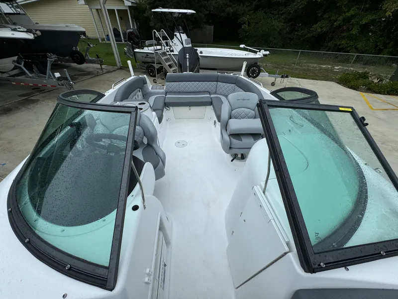 Slide: The Image of 2025 NauticStar 243 DC Deck boat with spacious seating and sleek design. - 15