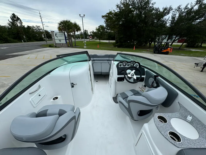 Slide: The Image of 2025 NauticStar 243 DC Deck boat interior with modern seating and dashboard. - 19