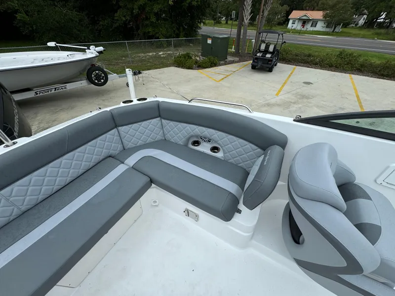 Slide: The Image of 2025 NauticStar 243 DC Deck boat with gray seating and modern design. - 23