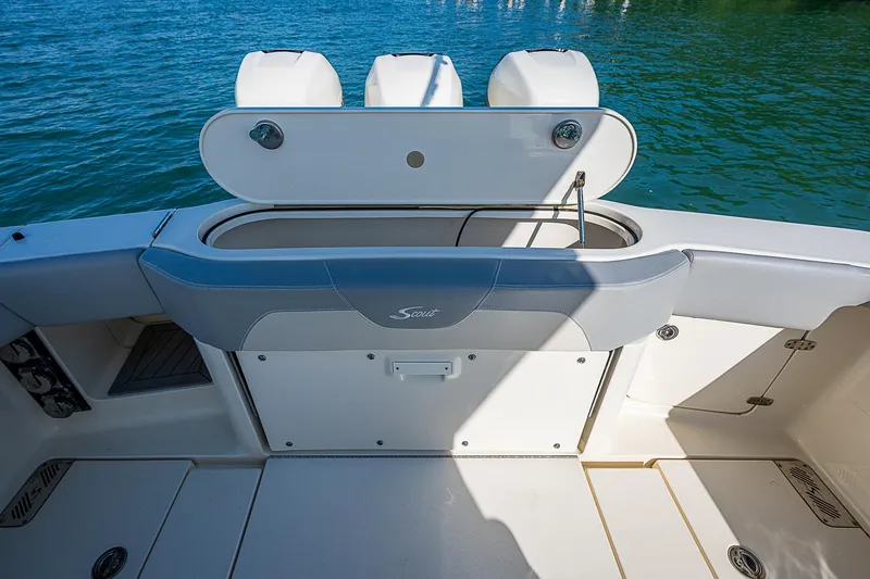 Slide: The Image of 2023 Scout LXF boat deck with seating and storage, on calm water. - 22