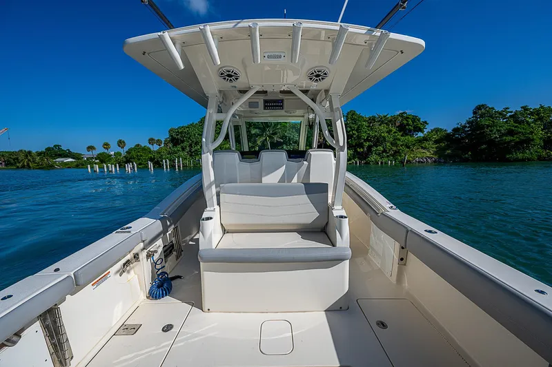 Slide: The Image of 2023 Scout LXF boat interior with seating, on a sunny day by the water. - 23