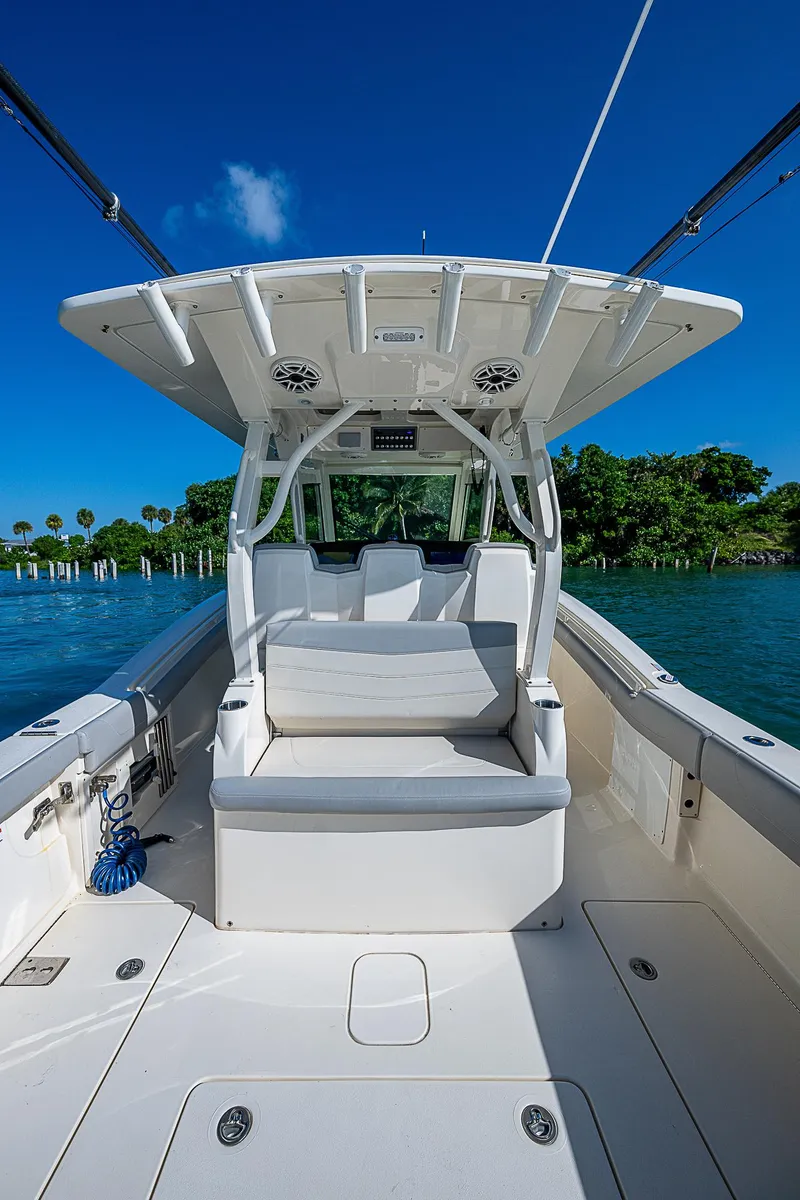 Slide: The Image of 2023 Scout LXF boat interior with seating, blue sky, and water backdrop. - 24
