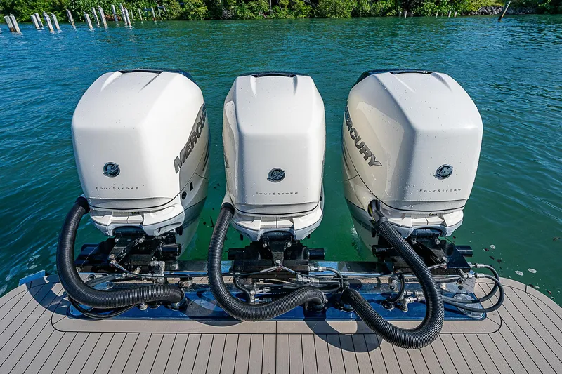 Slide: The Image of Triple Mercury outboard engines on 2023 Scout LXF boat, docked on clear water. - 29