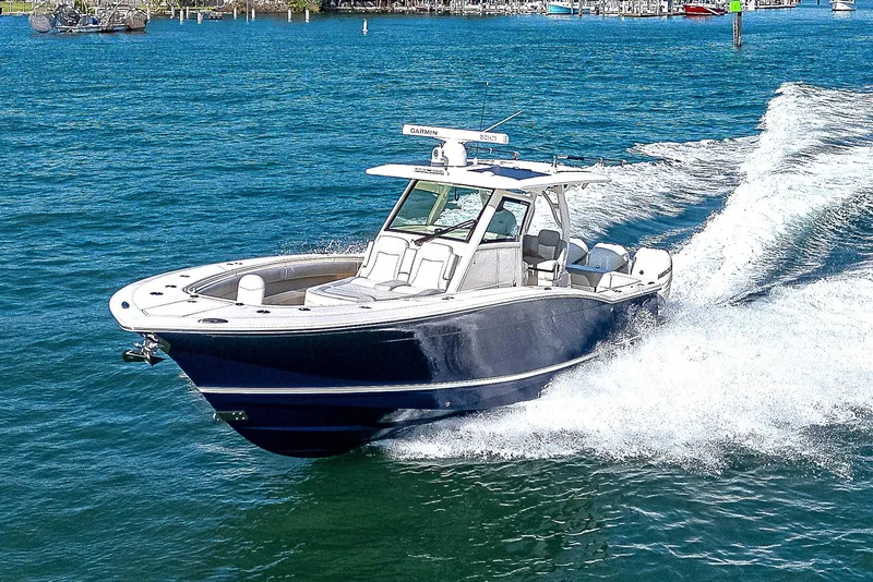 Slide: The Image of 2023 Scout LXF boat cruising on blue water, creating a dynamic wake. - 36