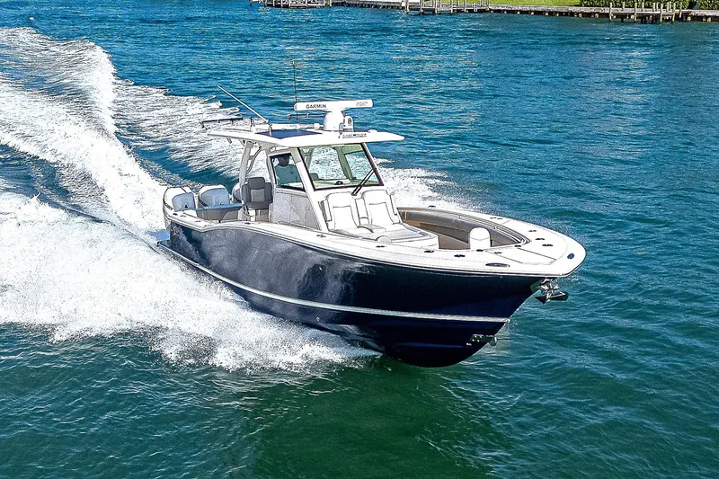 Slide: The Image of 2023 Scout LXF boat cruising on clear blue water. - 39