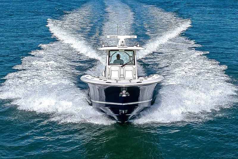 Slide: The Image of 2023 Scout LXF boat cruising on open water, creating a dynamic wake. - 40