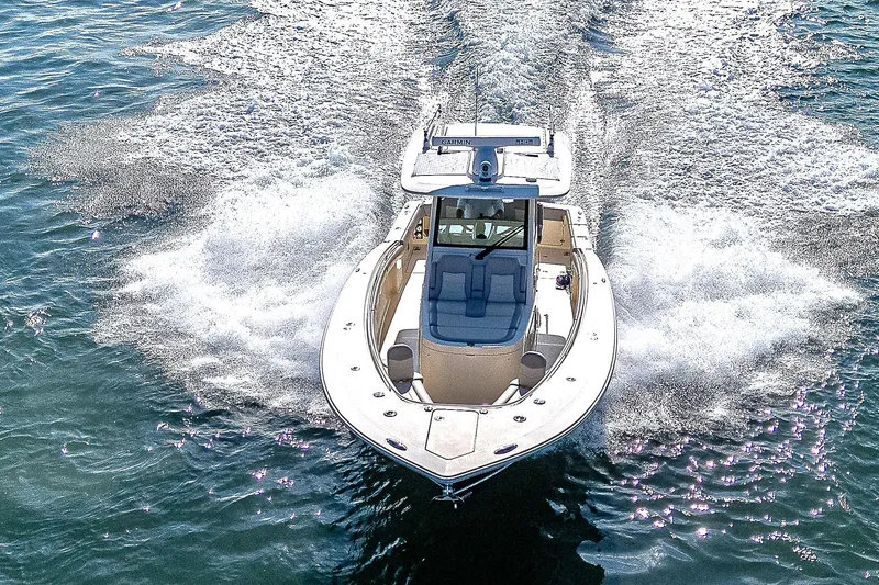 Slide: The Image of 2023 Scout LXF boat cruising on open water, creating a dynamic wake. - 41