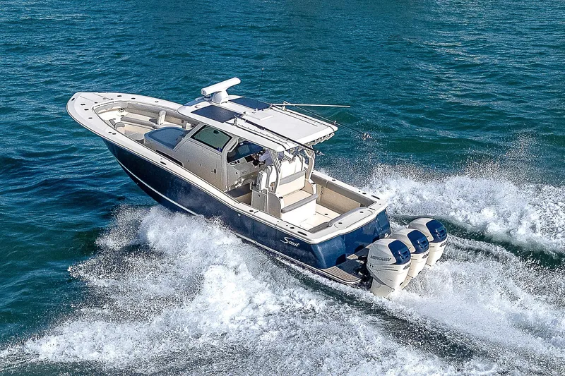 Slide: The Image of 2023 Scout LXF boat cruising on open water with powerful engines. - 42