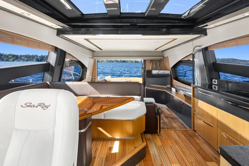 Slide: The Image of Luxurious interior of 2017 Sea Ray L590 Sport yacht with panoramic windows and elegant wood finishes. - 12