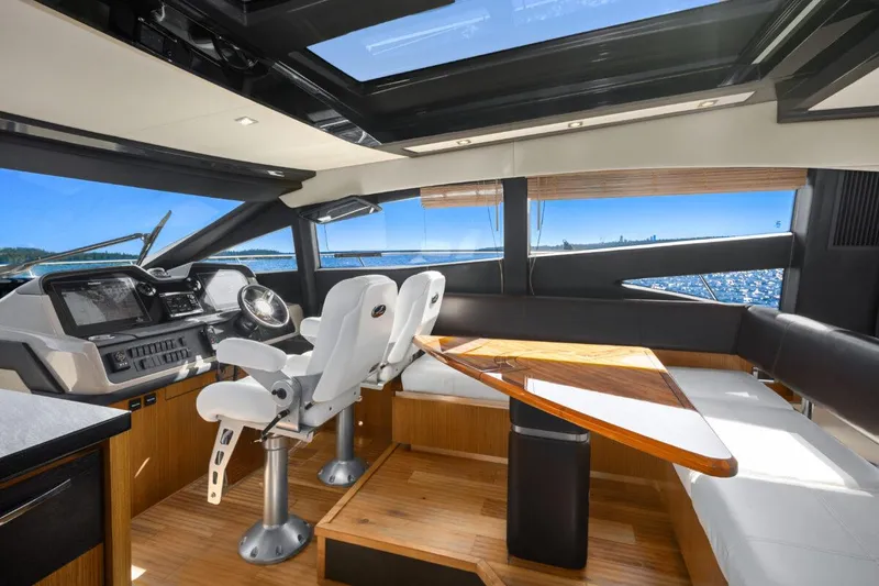 Slide: The Image of Luxurious interior of 2017 Sea Ray L590 Sport yacht with helm and seating area. - 13