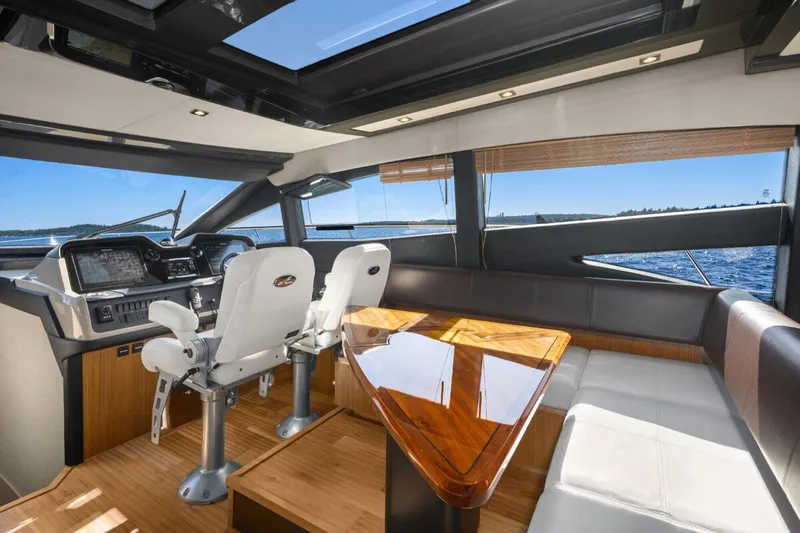 Slide: The Image of Luxurious interior of 2017 Sea Ray L590 Sport yacht with modern helm and seating. - 14