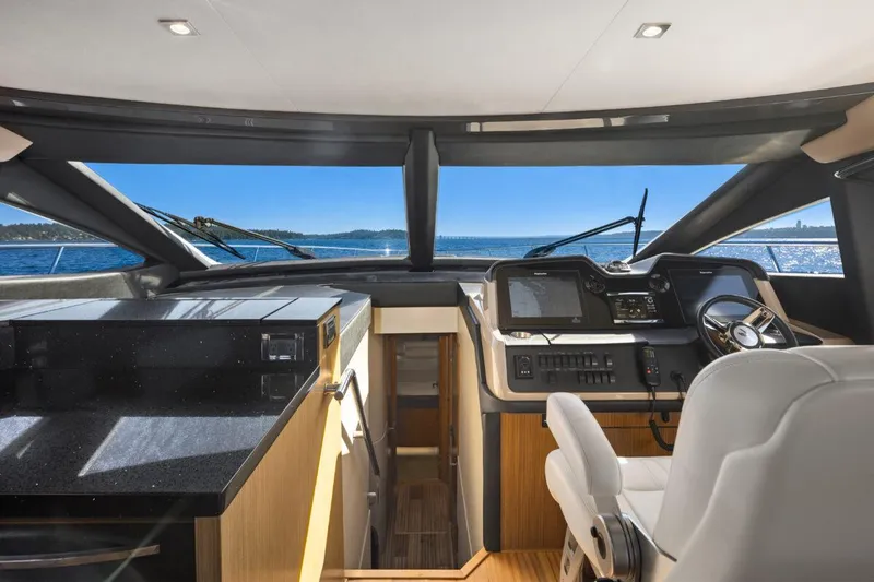 Slide: The Image of Luxurious 2017 Sea Ray L590 Sport yacht interior with modern helm and panoramic ocean view. - 17