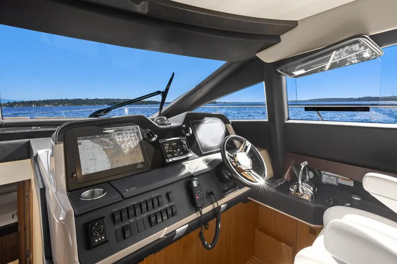 Slide: The Image of Interior of 2017 Sea Ray L590 Sport yacht, featuring modern navigation controls and luxurious seating. - 18