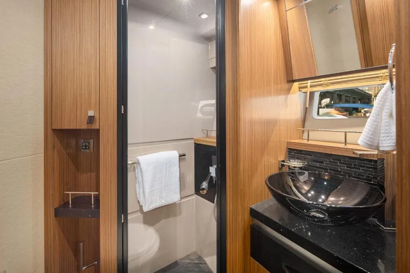 Slide: The Image of Luxurious bathroom in 2017 Sea Ray L590 Sport yacht with modern fixtures and wood accents. - 29