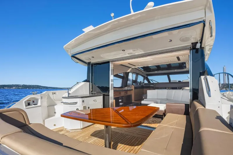 Slide: The Image of 2017 Sea Ray L590 Sport yacht with luxurious seating and dining area on deck. - 33