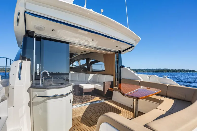 Slide: The Image of 2017 Sea Ray L590 Sport yacht with luxurious deck seating and ocean view. - 34